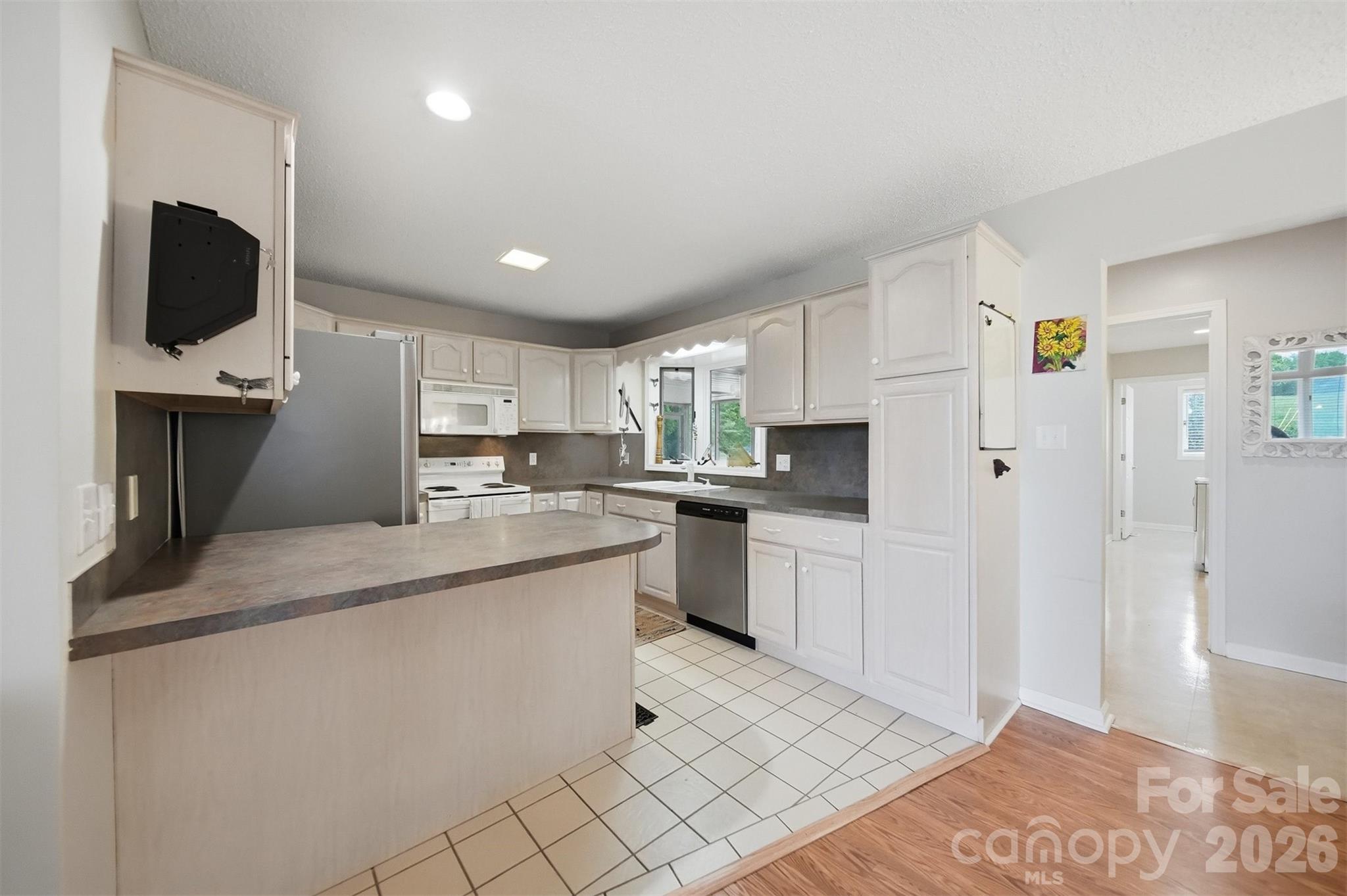 192 Reese Loop Taylorsville, NC 28681 - Photo 11 of 41 a kitchen with stainless steel appliances granite countertop a sink refrigerator and microwave