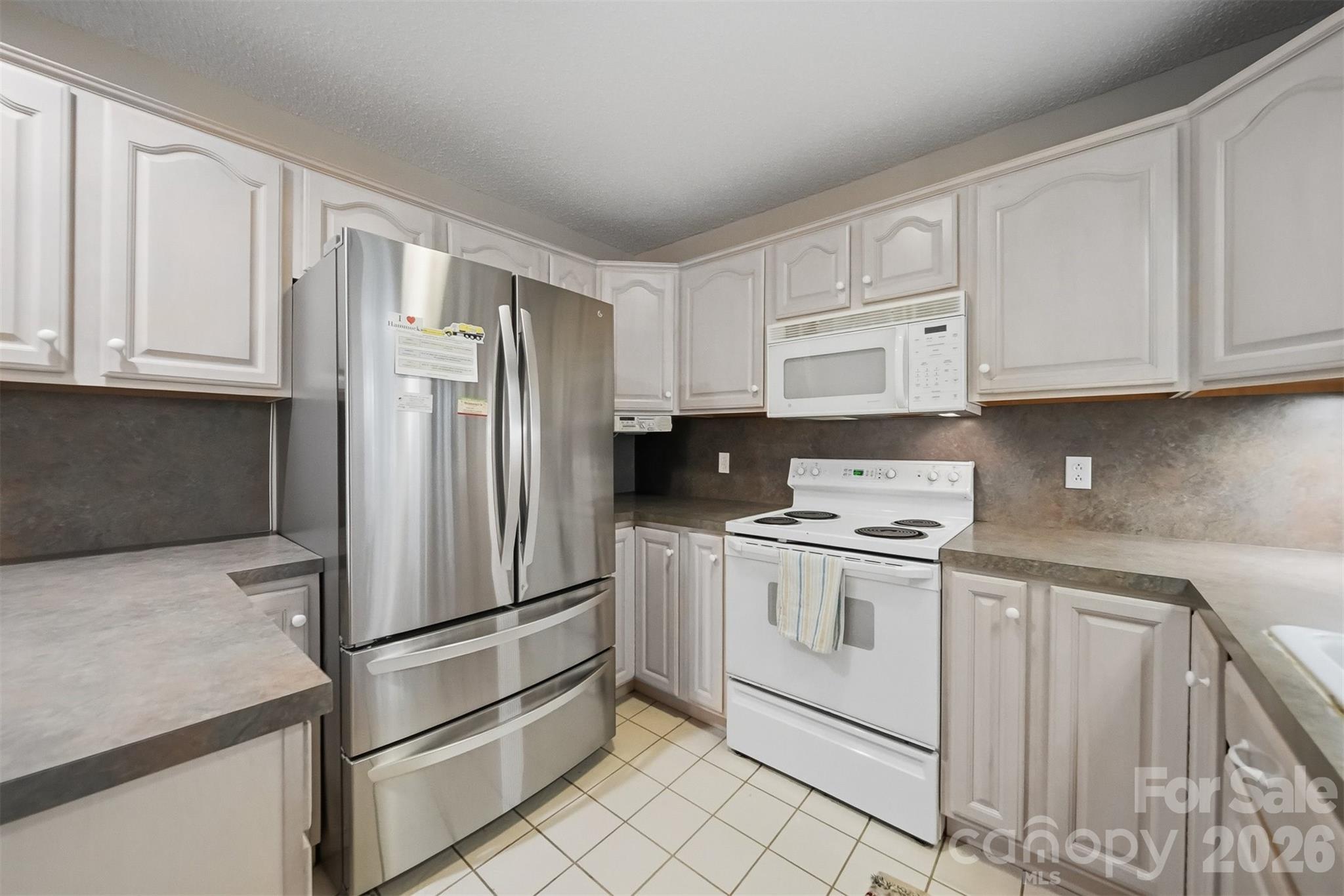 192 Reese Loop Taylorsville, NC 28681 - Photo 12 of 41 a kitchen with stainless steel appliances granite countertop a refrigerator sink and cabinets