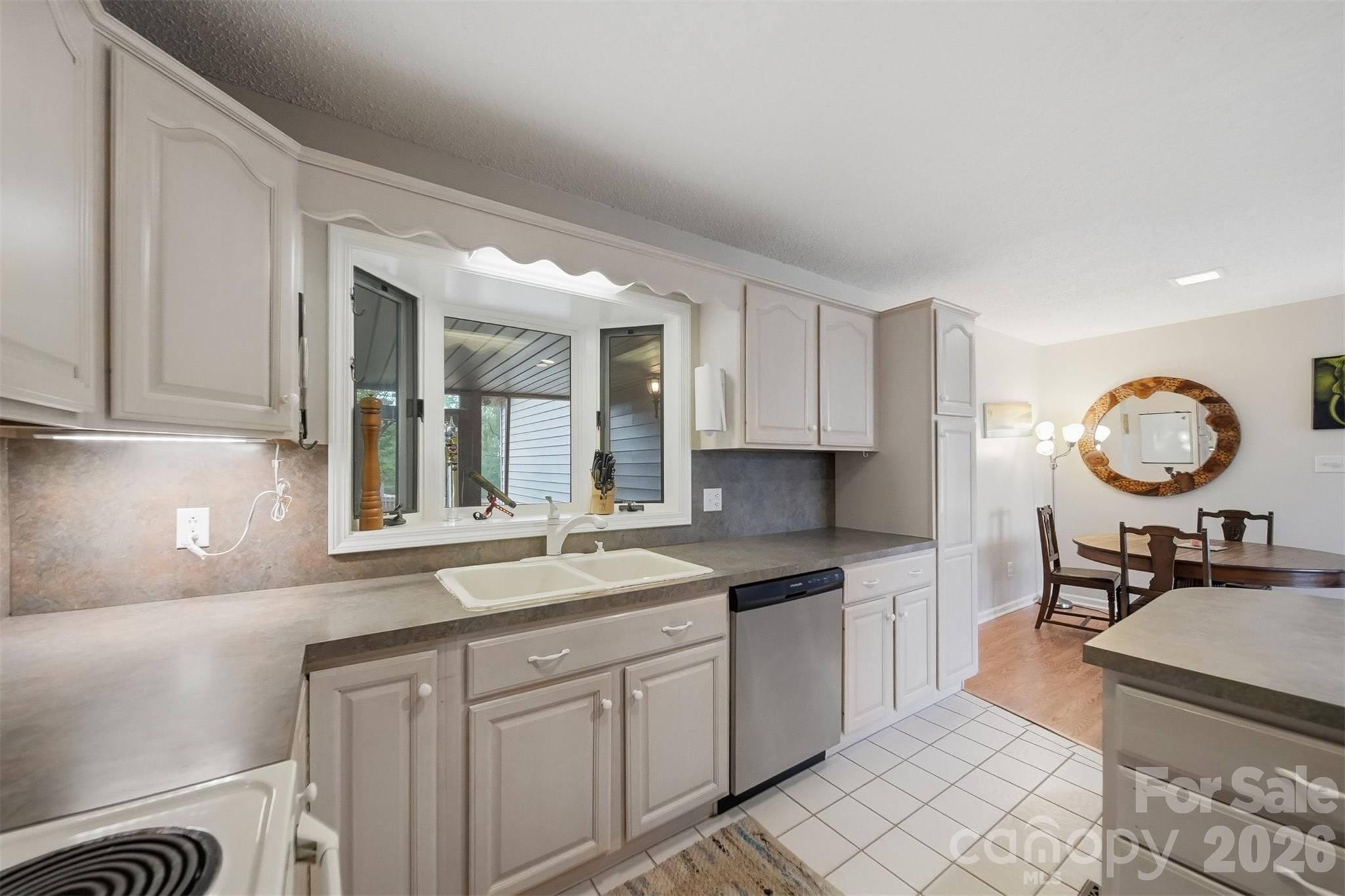 192 Reese Loop Taylorsville, NC 28681 - Photo 13 of 41 a kitchen with granite countertop a sink cabinets and window