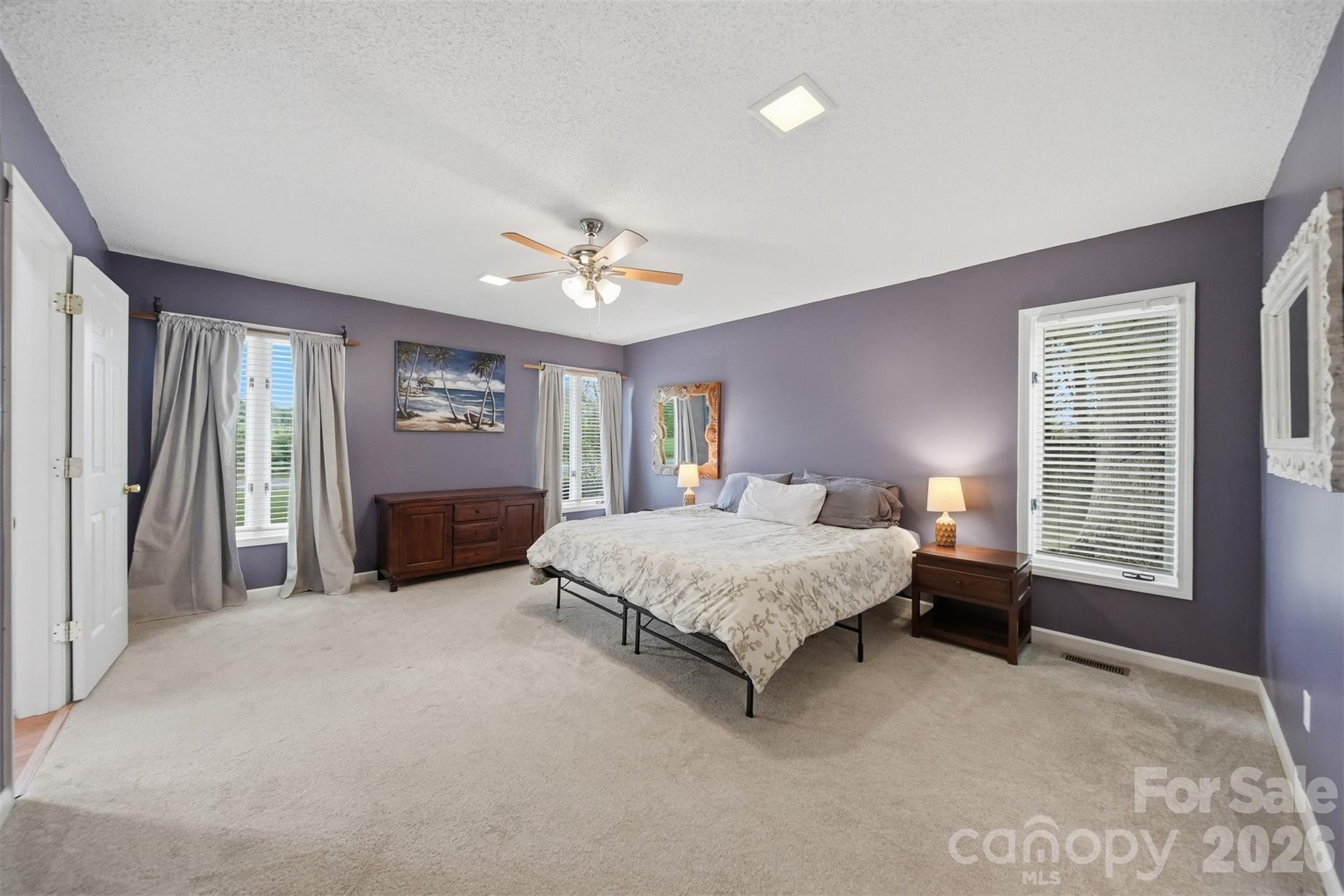 192 Reese Loop Taylorsville, NC 28681 - Photo 17 of 41 a spacious bedroom with a large bed and a chandelier