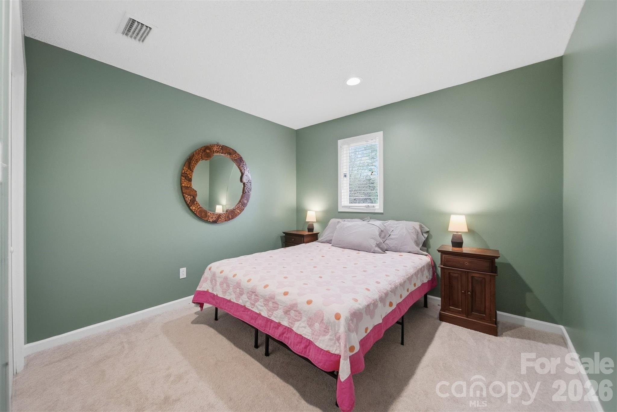 192 Reese Loop Taylorsville, NC 28681 - Photo 22 of 41 a bedroom with a bed a mirror and a window