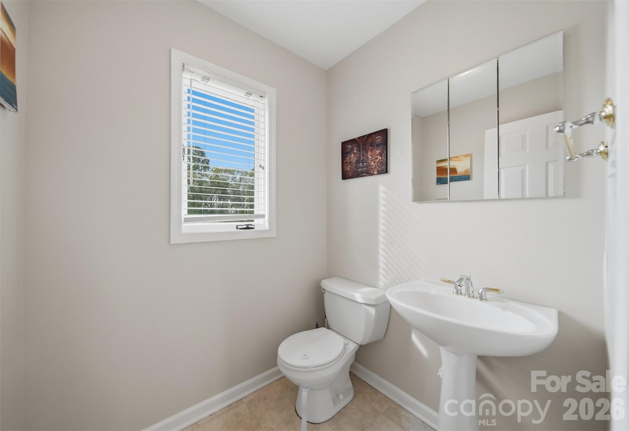 192 Reese Loop Taylorsville, NC 28681 - Photo 25 of 41 a bathroom with a toilet sink and mirror