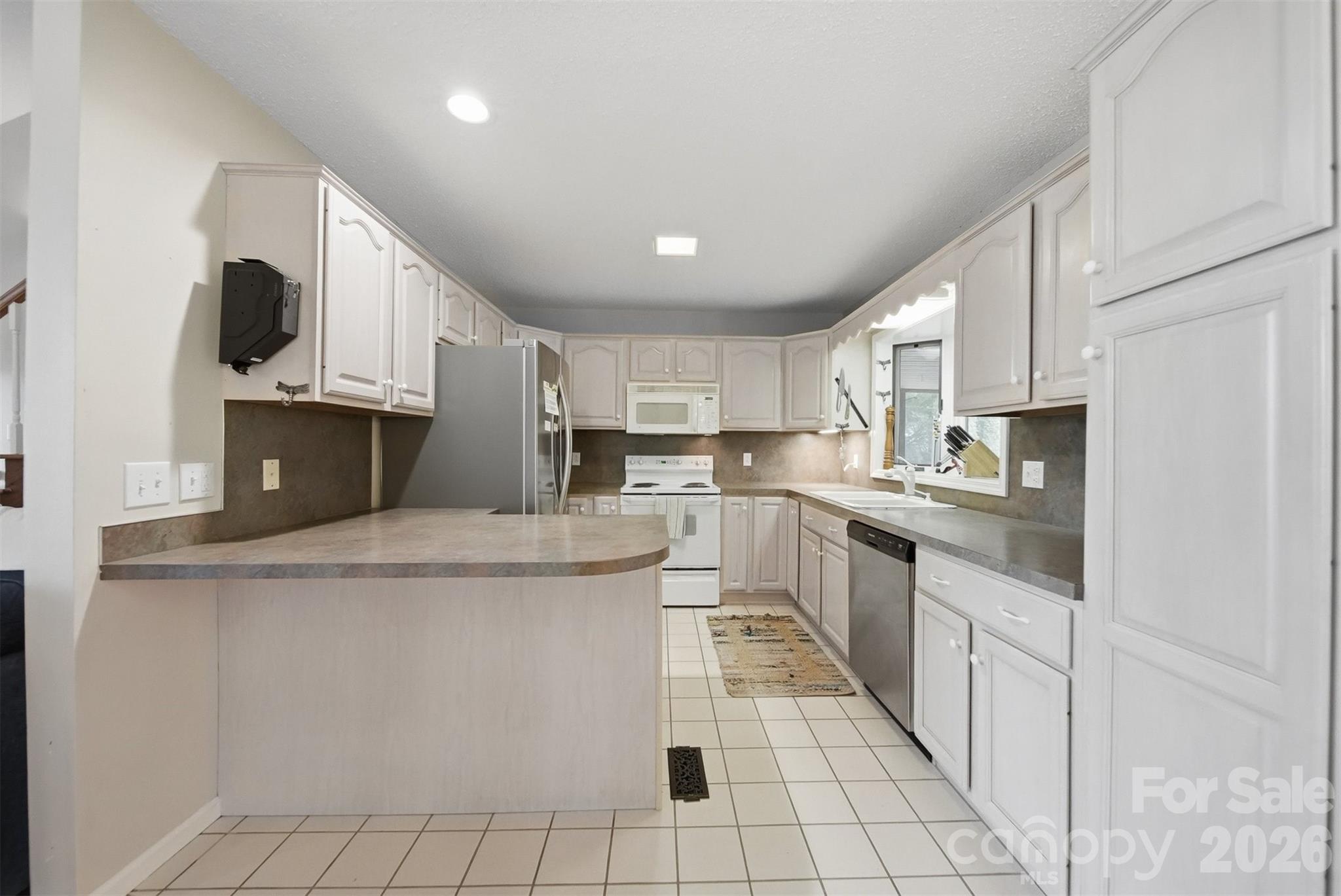 192 Reese Loop Taylorsville, NC 28681 - Photo 10 of 41 a kitchen with stainless steel appliances kitchen island granite countertop a sink and a stove
