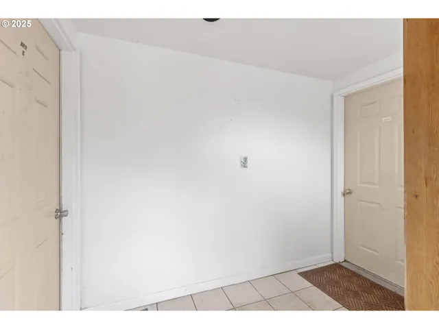 a view of a livingroom with workspace and a window