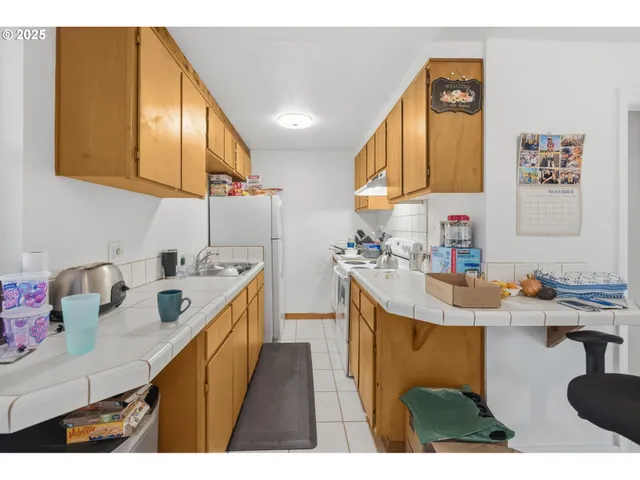 a living room with lots of furniture and clutter