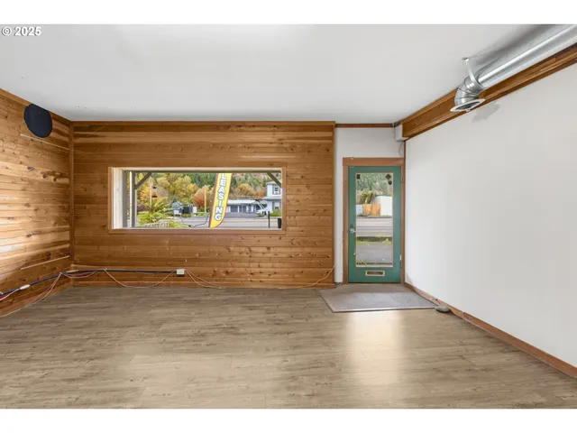 a view of an empty room with wooden floor