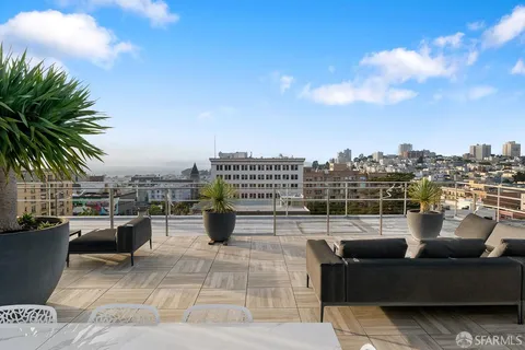 a view of roof deck with a barbeque and wooden stairs