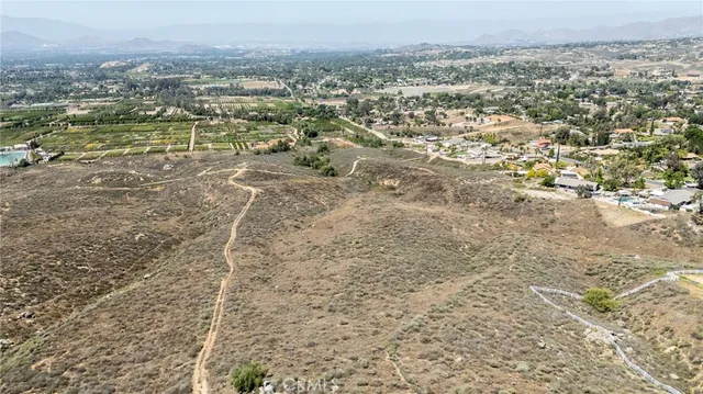 an aerial view of a residential houses with city view