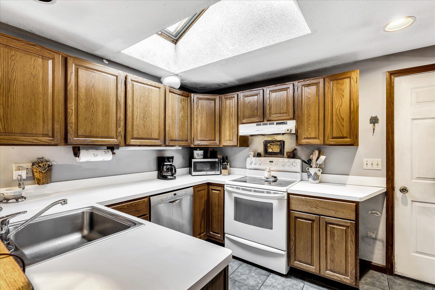 11 Barnacle Lane Mashpee, MA 02649 - Photo 18 of 38 a kitchen with a stove sink and cabinets