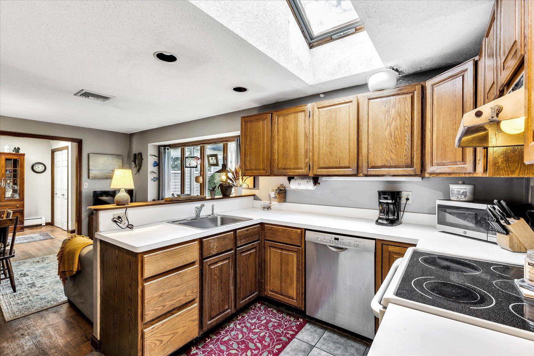 11 Barnacle Lane Mashpee, MA 02649 - Photo 19 of 38 a kitchen with a sink stove and cabinets