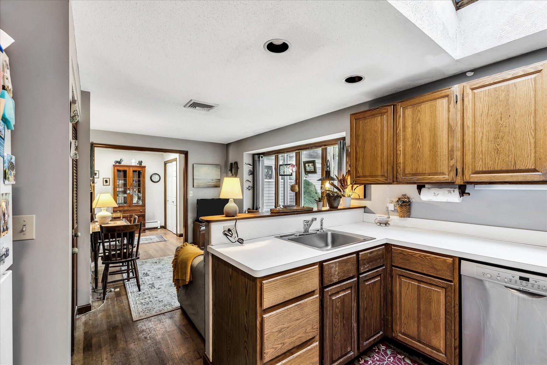 11 Barnacle Lane Mashpee, MA 02649 - Photo 20 of 38 a kitchen with a sink window and cabinets