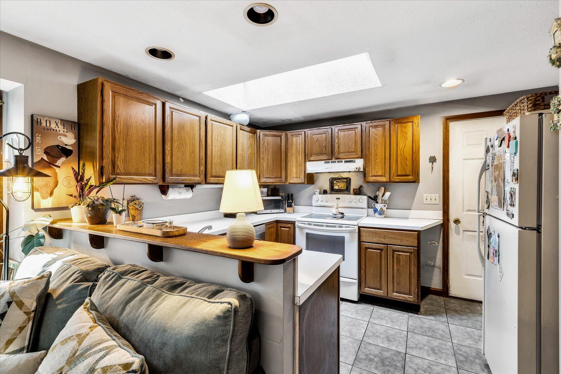11 Barnacle Lane Mashpee, MA 02649 - Photo 21 of 38 a kitchen that has a lot of cabinets in it and stainless steel appliances