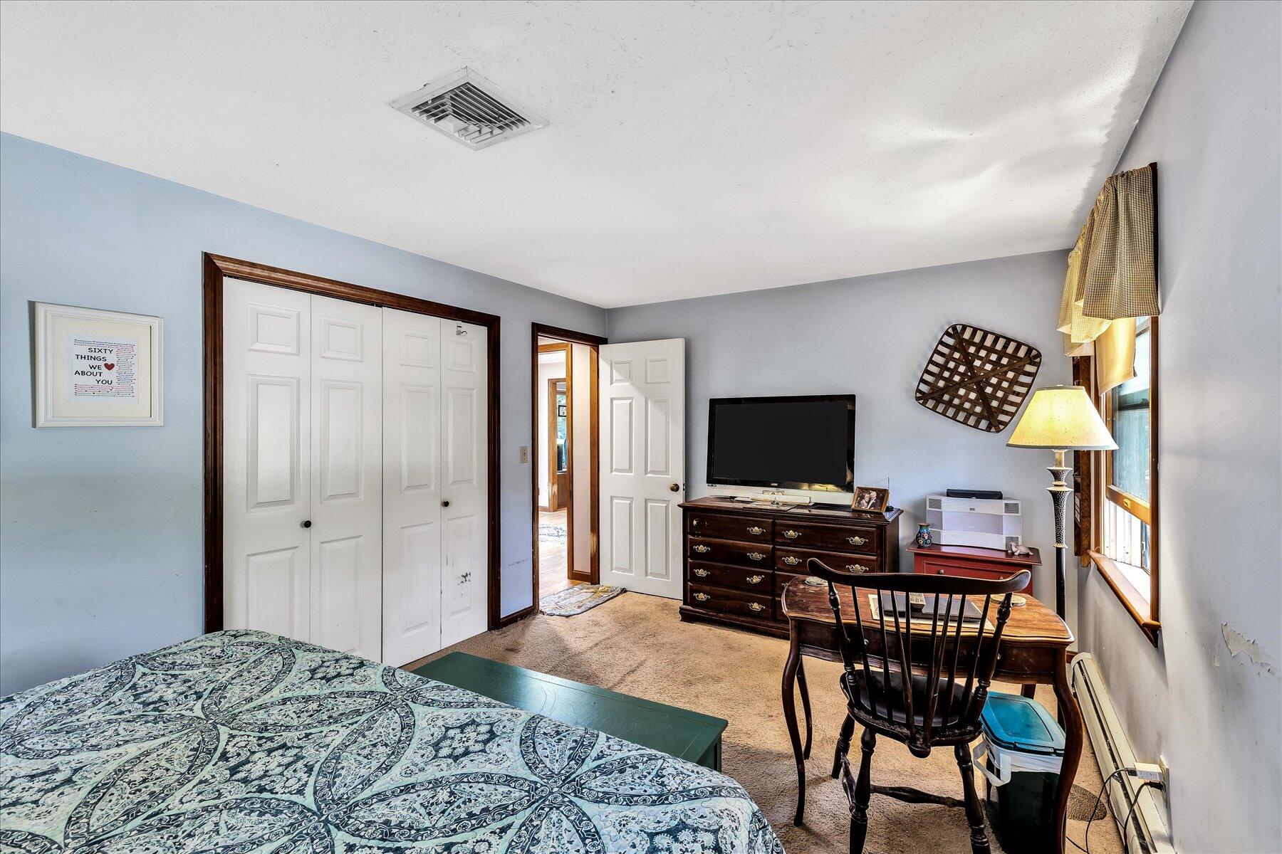 11 Barnacle Lane Mashpee, MA 02649 - Photo 24 of 38 a bedroom with furniture and a flat screen tv