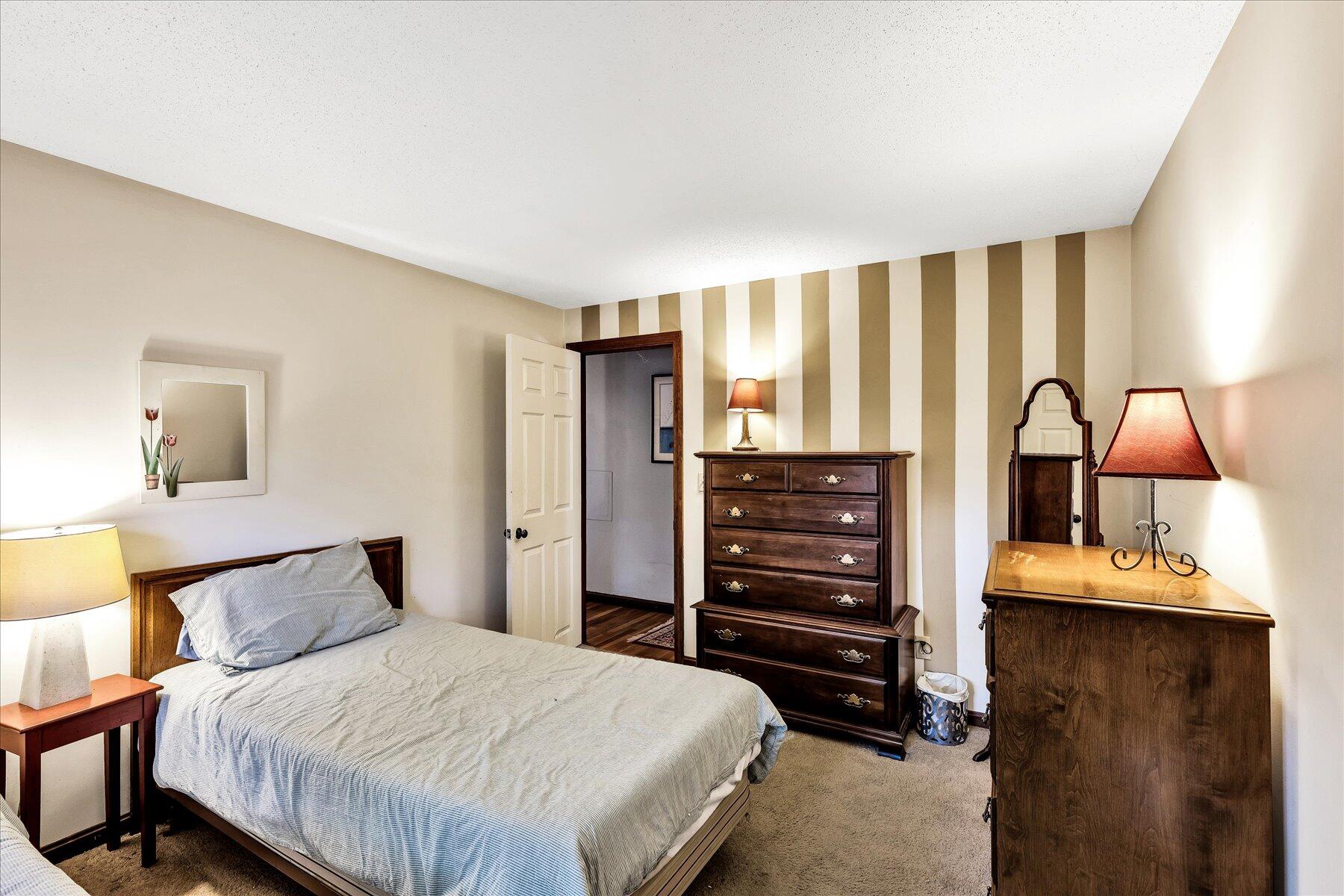 11 Barnacle Lane Mashpee, MA 02649 - Photo 25 of 38 a bedroom with a bed and dresser with mirror