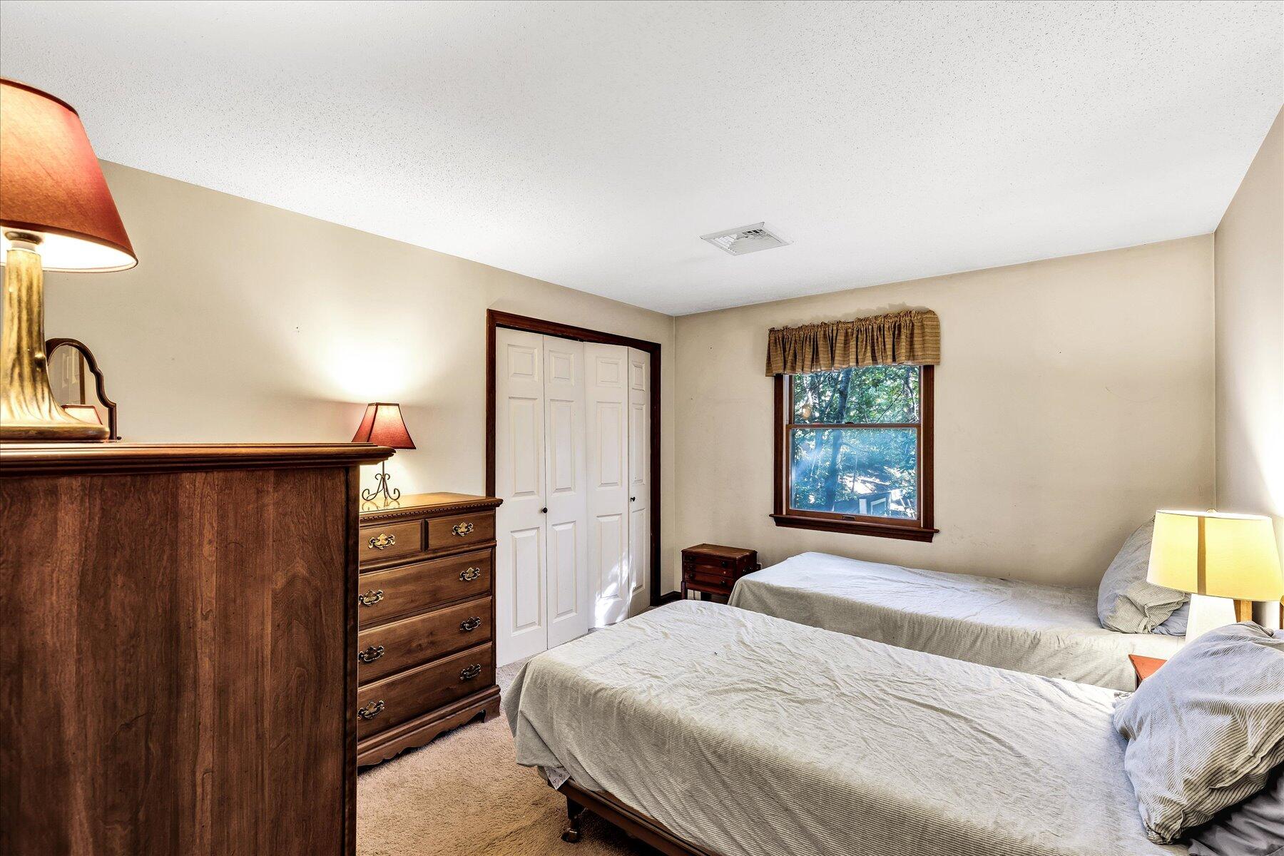 11 Barnacle Lane Mashpee, MA 02649 - Photo 26 of 38 a bedroom with a bed and a dresser