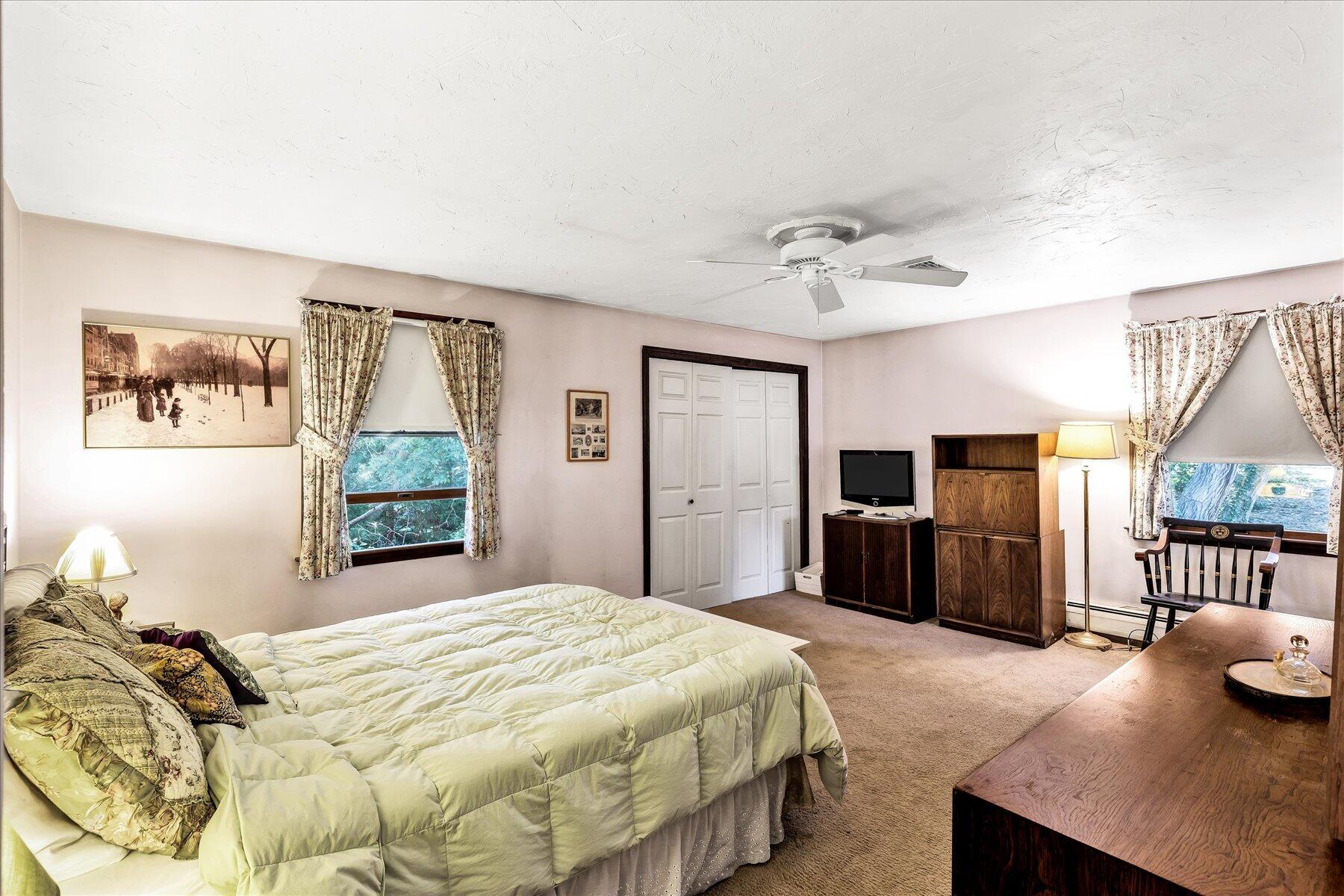 11 Barnacle Lane Mashpee, MA 02649 - Photo 28 of 38 a bedroom with a bed flat screen tv and a large window