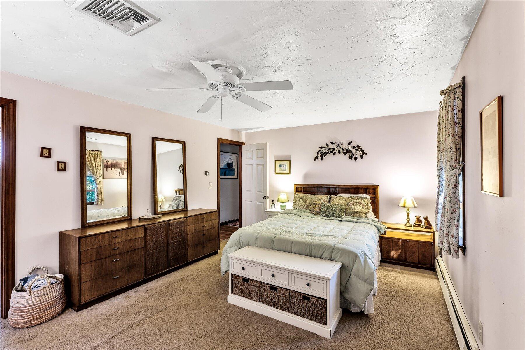 11 Barnacle Lane Mashpee, MA 02649 - Photo 29 of 38 a spacious bedroom with a bed and glass windows