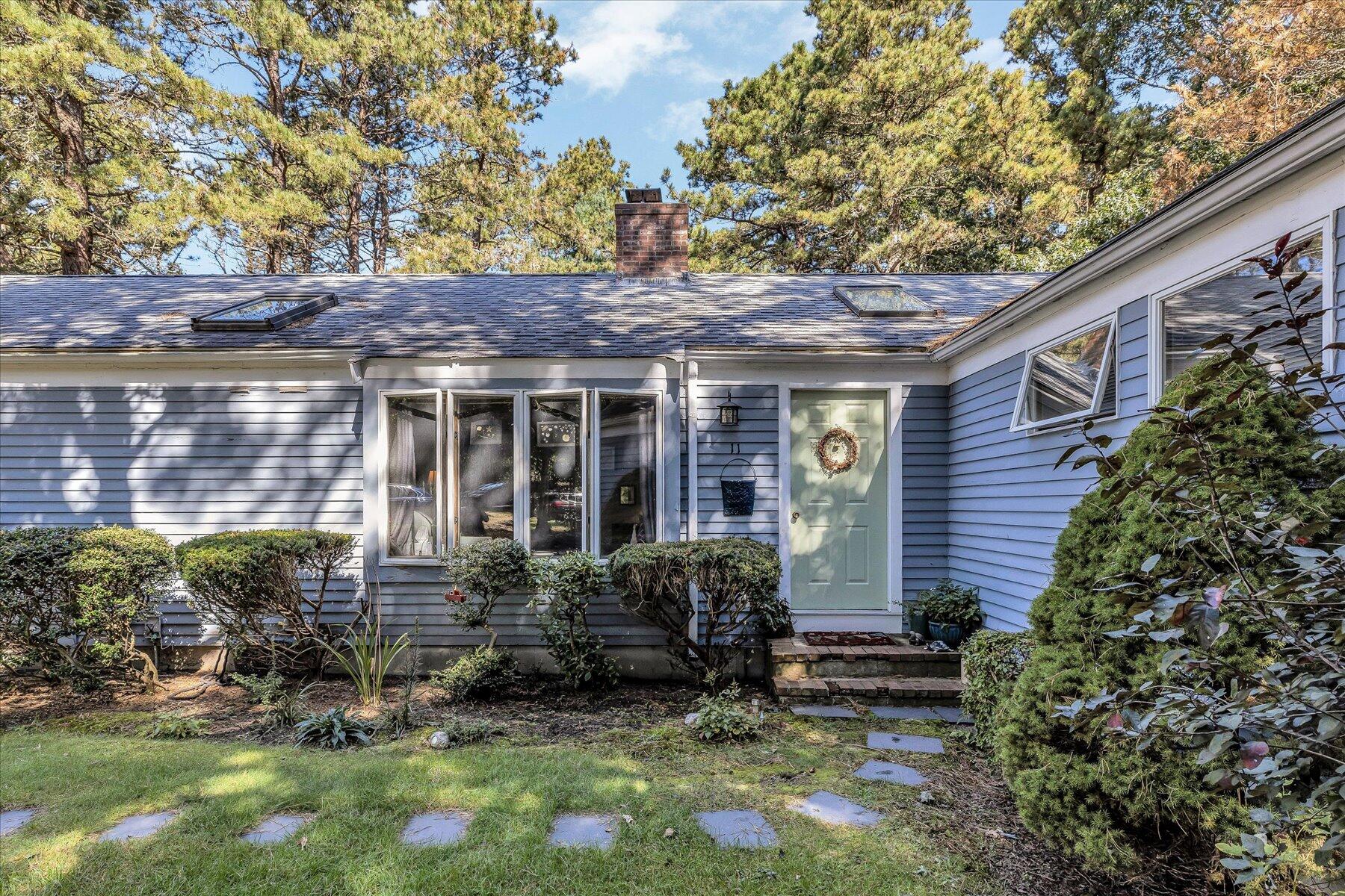 11 Barnacle Lane Mashpee, MA 02649 - Photo 3 of 38 a front view of a house with garden