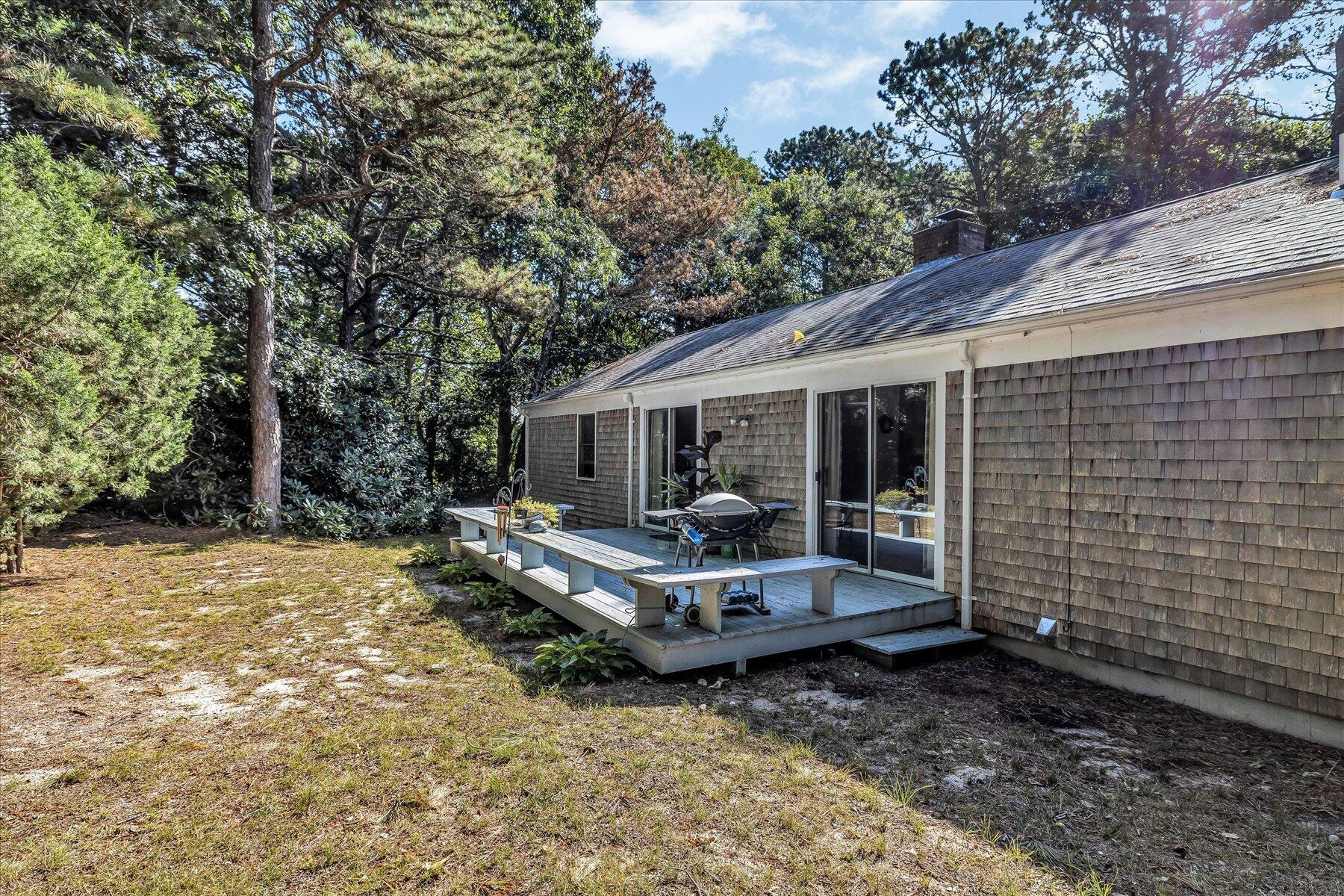 11 Barnacle Lane Mashpee, MA 02649 - Photo 34 of 38 a view of a house with backyard and sitting area