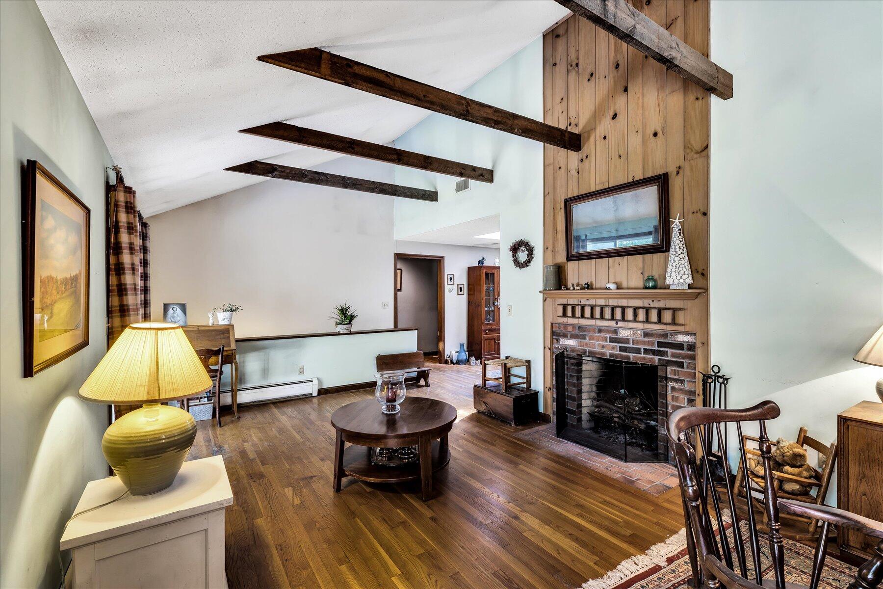 11 Barnacle Lane Mashpee, MA 02649 - Photo 7 of 38 a living room with furniture a fireplace and a flat screen tv