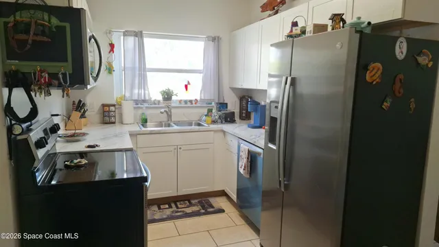 a kitchen with a sink appliances and cabinets