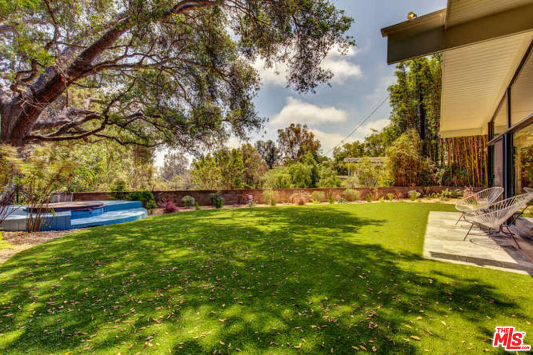 810 Bramble Way Los Angeles, CA 90049 - Photo 30 of 32 a view of yard with swimming pool and green space