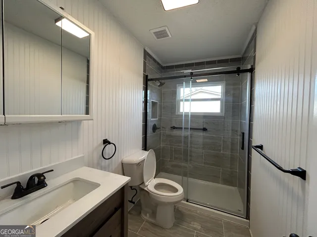 a bathroom with a sink toilet and shower