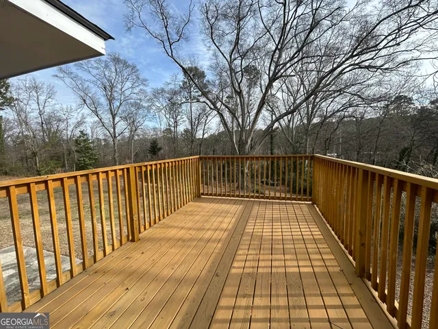 a view of balcony with wooden floor and trees