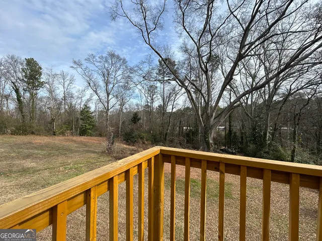 a view of a wooden deck next to a yard