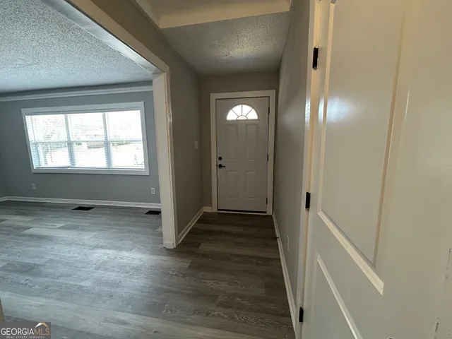 an empty room with closet and windows