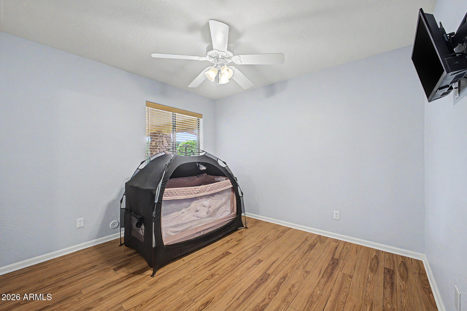 802 East Roberts Road Phoenix, AZ 85022 - Photo 16 of 24 a room with wooden floor and chandelier