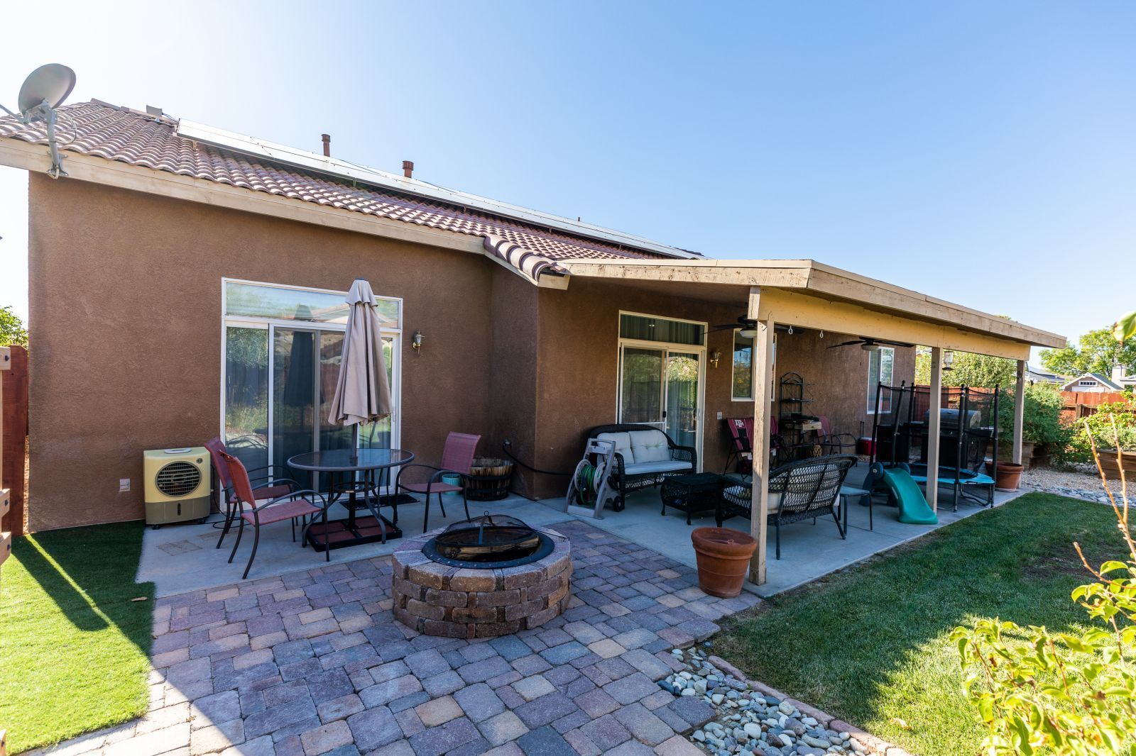 718 Pinon Court Ridgecrest, CA 93555 - Photo 35 of 41 a view of a house with backyard sitting area and a garden