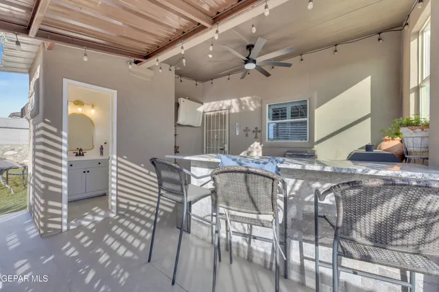 a view of a dining room with furniture and a chandelier