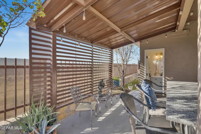 a view of balcony with a table and chairs