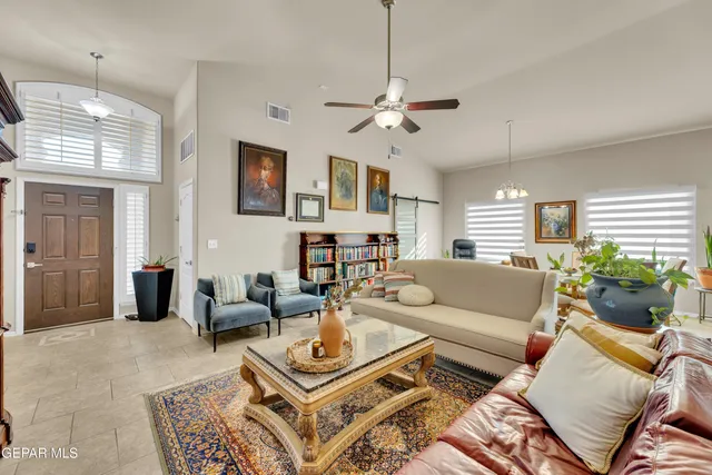 a living room with furniture a chandelier and a window