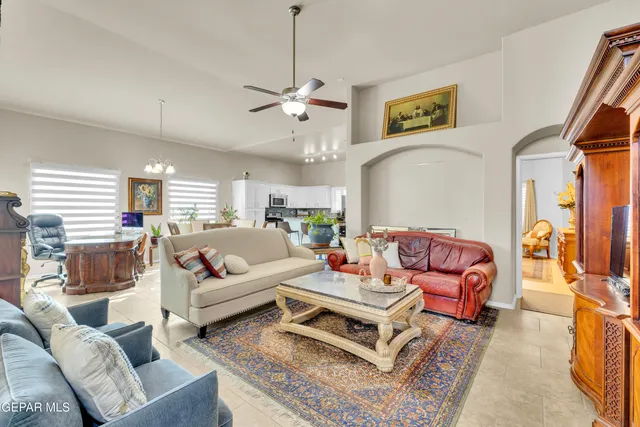 a living room with furniture ceiling fan and a rug