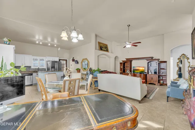 a living room with furniture and a chandelier