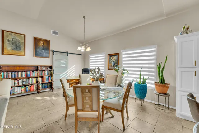 a dining room with furniture and window