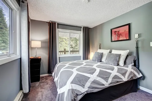 a bed sitting in a bedroom next to a window