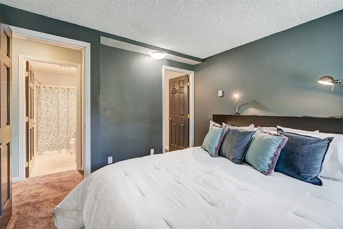 73 Illinois Gulch Road, Unit 8 Breckenridge, CO 80424 - Photo 15 of 24 a bedroom with a large bed and a large mirror