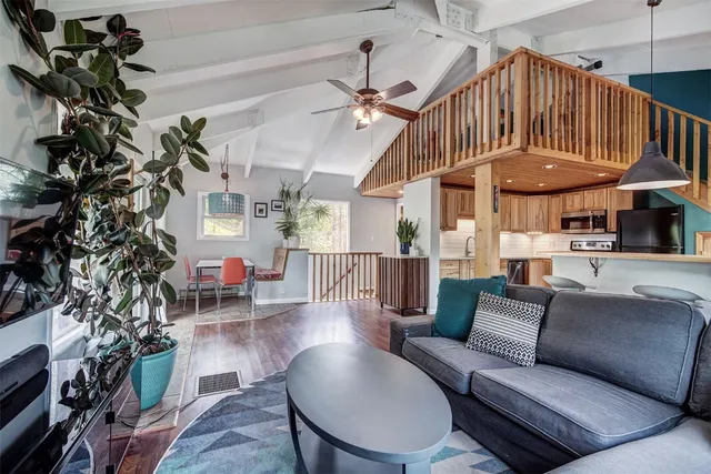 a living room with furniture a fireplace and a chandelier