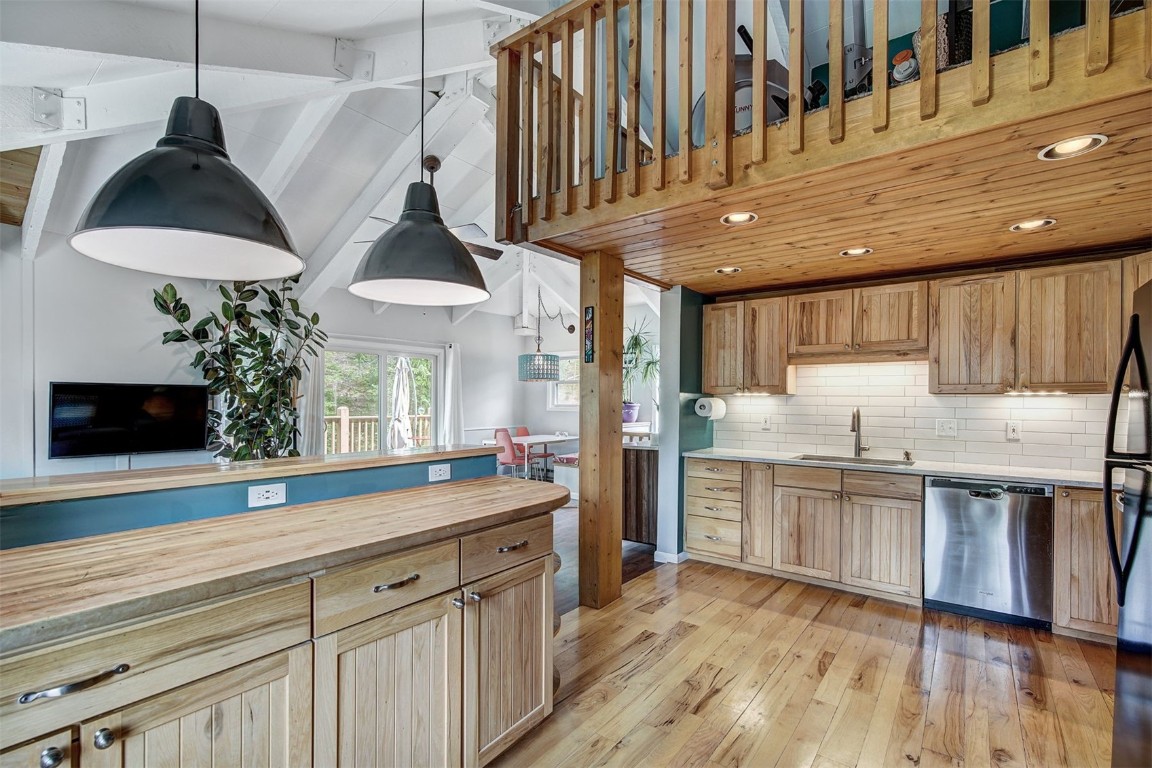 73 Illinois Gulch Road, Unit 8 Breckenridge, CO 80424 - Photo 10 of 24 a kitchen with stainless steel appliances granite countertop a sink a stove and a wooden floors