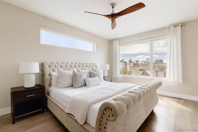 a bedroom with a large bed and a window