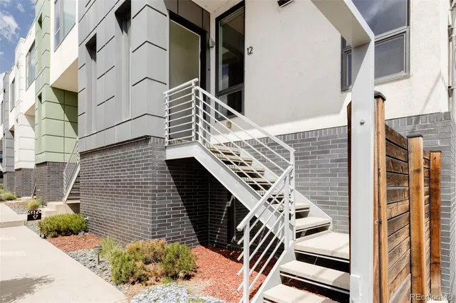 a living room with furniture wooden floor and a large window
