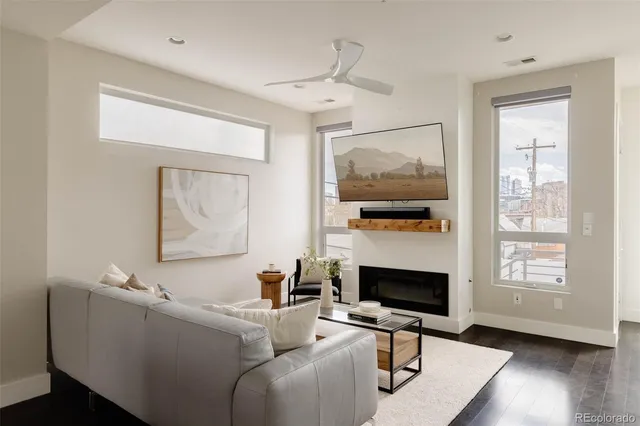 a kitchen with stainless steel appliances a table chairs and white cabinets