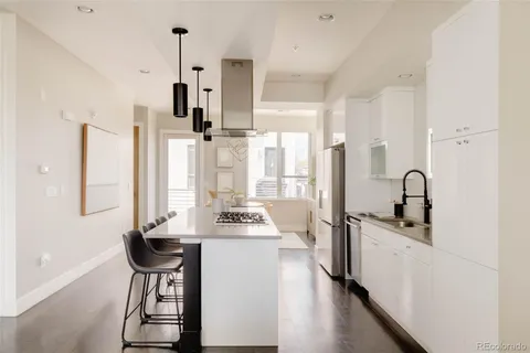a kitchen with stainless steel appliances a sink stove and refrigerator