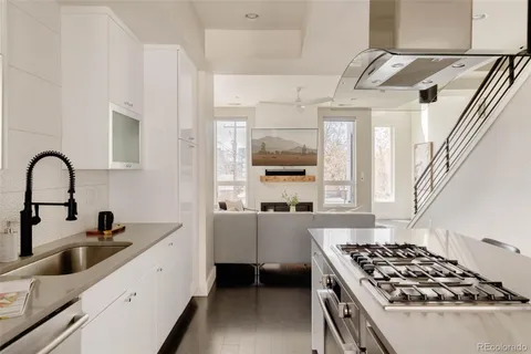 a kitchen with stainless steel appliances a stove a sink and a microwave