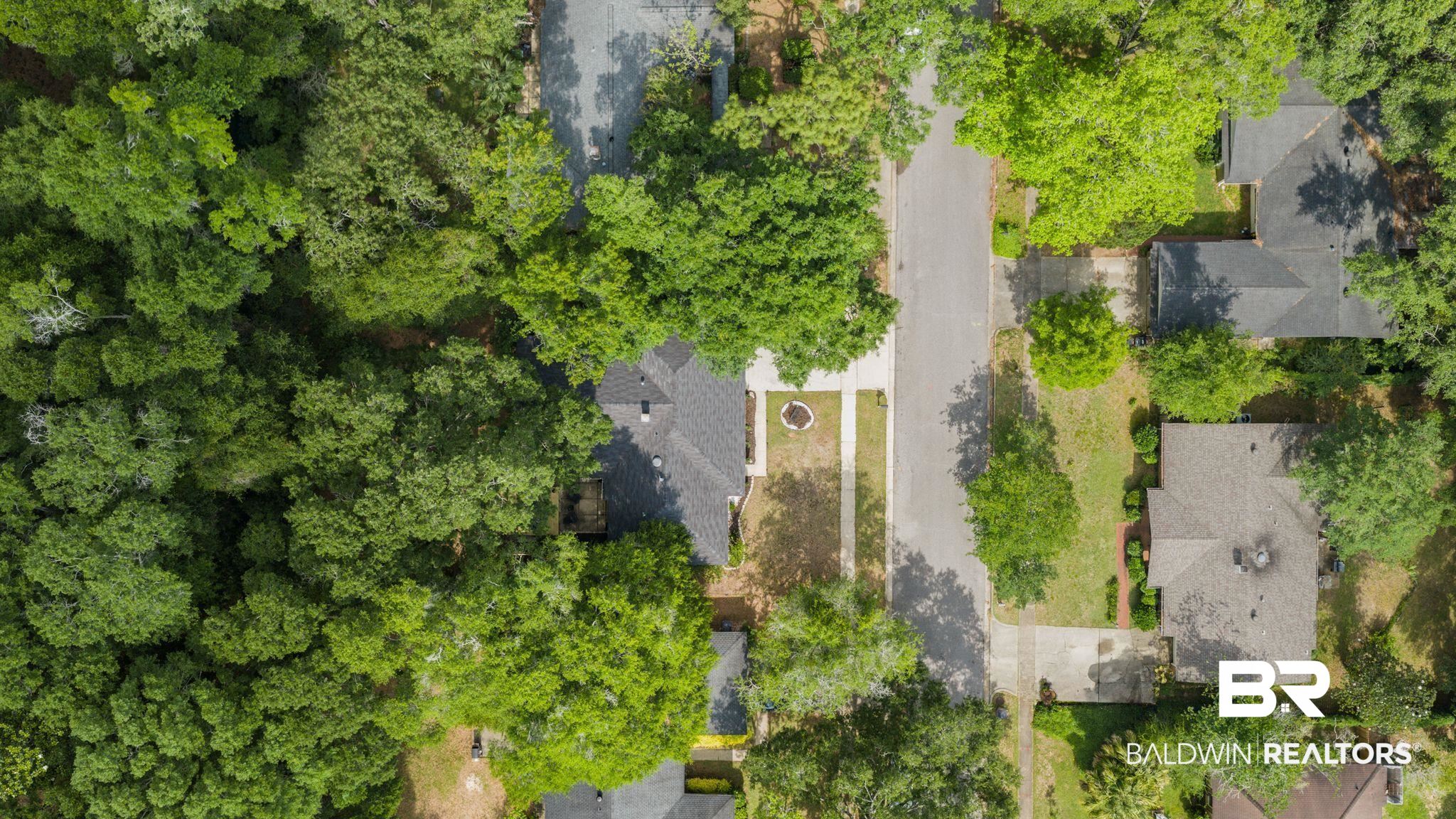 4724 Wicker Way Mobile, AL 36609 - Photo 35 of 36 Aerial perspective highlighting a residential street with homes featuring dark shingle roofs, individual driveways, and surrounding mature trees