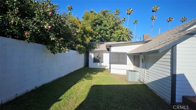 a view of a roof deck with table and chairs with wooden floor and fence
