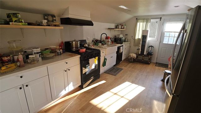 a kitchen with a sink a stove and cabinets